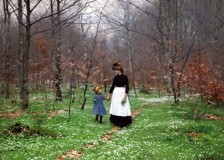 Mother and daughter walking hand in hand through a bare beech forest carpeted with white wood anemones.