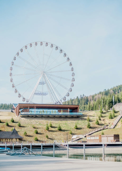 Ferris wheel overlooking pine forest and mountains at Bukovel resort, Carpathians