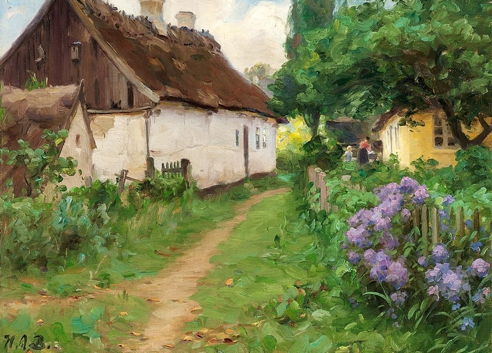 Garden path between a thatched cottage and yellow farmhouse with blooming purple hydrangeas