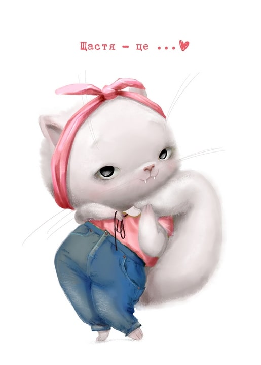 Біле кошеня в рожевій хустці та джинсовому комбінезоні в грайливій позі
