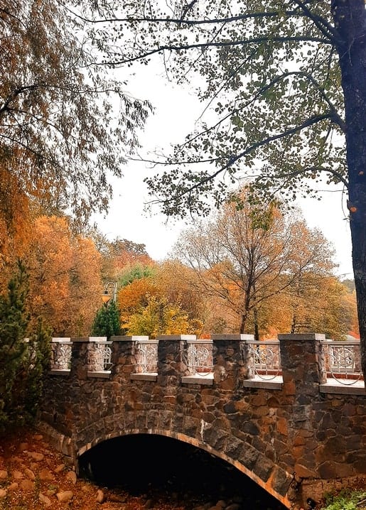 Photographic postcard — Feofania Park Kyiv, old stone arch bridge with carved balustrade. My Kyiv! series by Zolota Ptakha