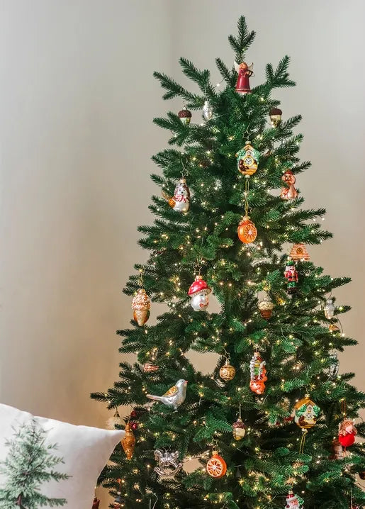 Christmas photo postcard featuring a green tree decorated with colourful ornaments and warm glowing fairy lights