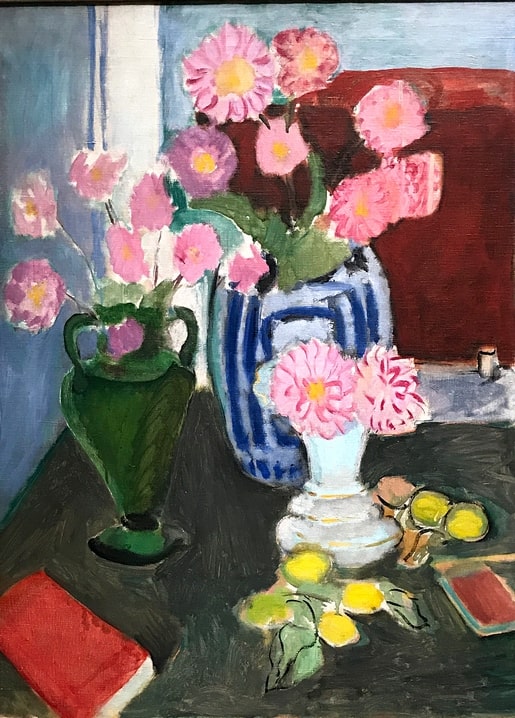 Pierre Bonnard still life with pink flowers in three vases, lemons and a red book on a dark table