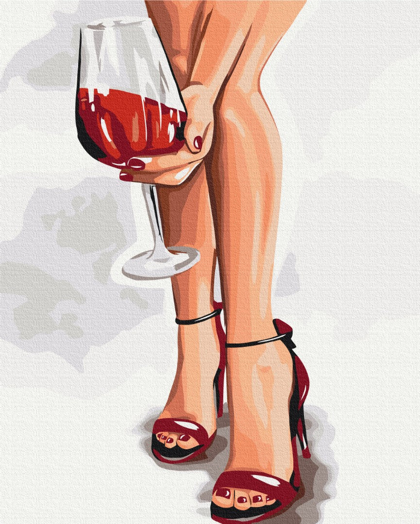 Rote High Heels und eine Hand mit einem Glas Rotwein