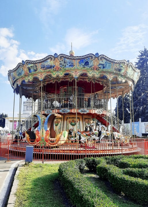 Vintage two-tier carousel with painted canopy at VDNG park in Kyiv