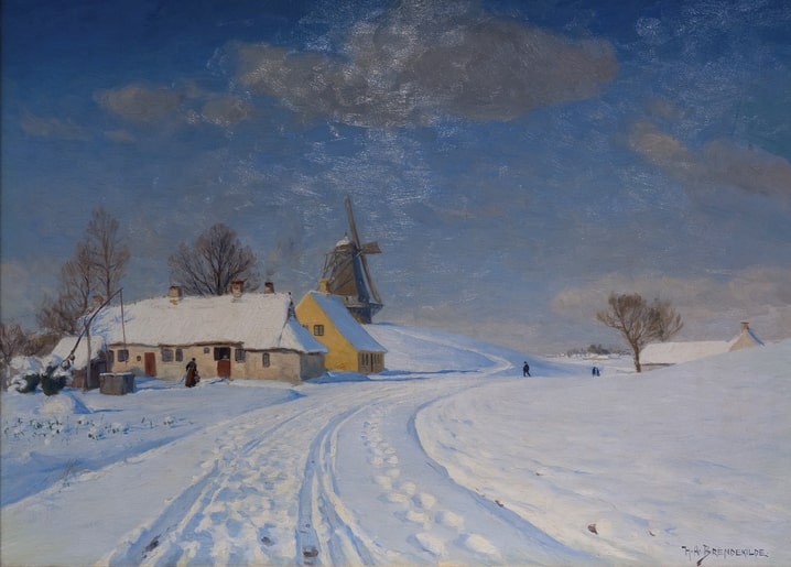 Snow-covered Danish farmstead with a windmill on the hill behind
