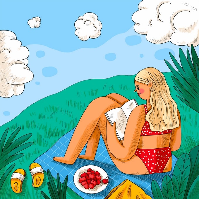 Woman reading a book on a picnic blanket with cherries and yellow sandals