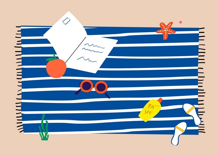 Striped beach towel with a postcard, pen, sunglasses, sunscreen, an orange, and a starfish