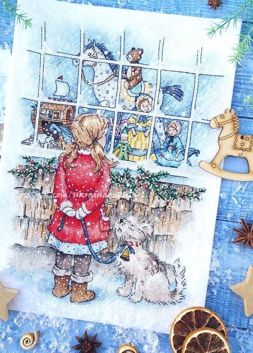 Cross-stitched girl in a red coat and her dog looking through a frosted window at a Christmas toy display.