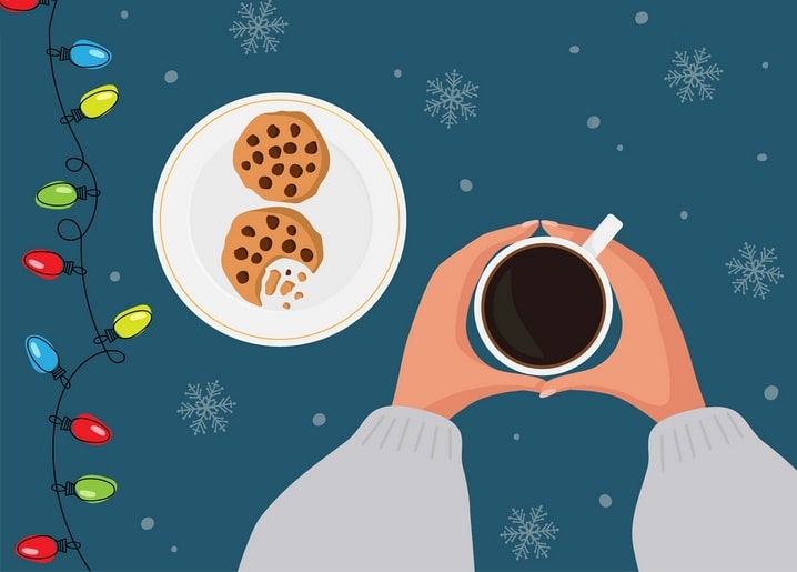 Top-down flat lay of coffee mug, chocolate chip cookies and colorful Christmas fairy lights on teal