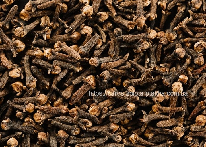 Close-up macro texture of whole dried cloves covering the frame edge to edge.