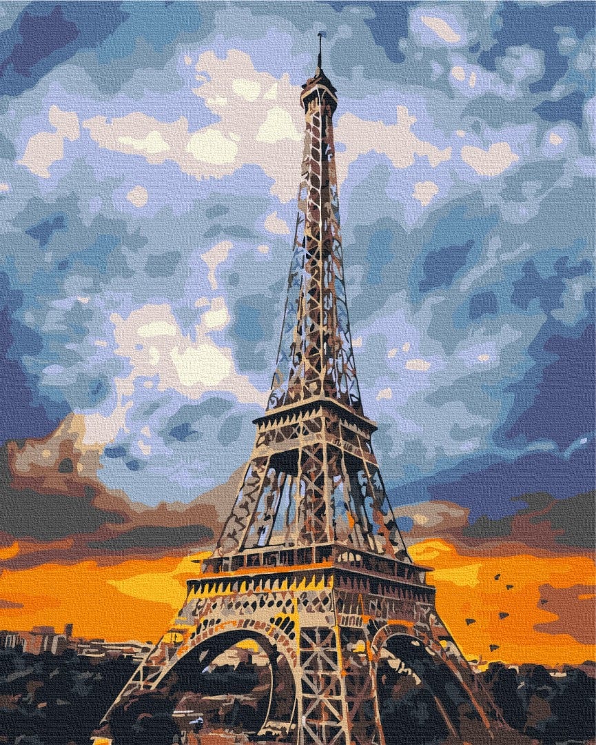 Eiffel Tower silhouette against a fiery orange and blue sunset sky