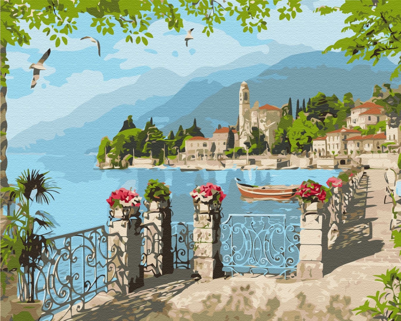 Italian lakeside town seen past a wrought-iron railing with pink flowers