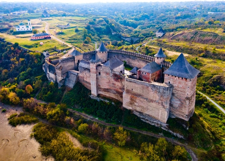 Aerial view of Khotyn Fortress on a cliff above the Dniester River in autumn