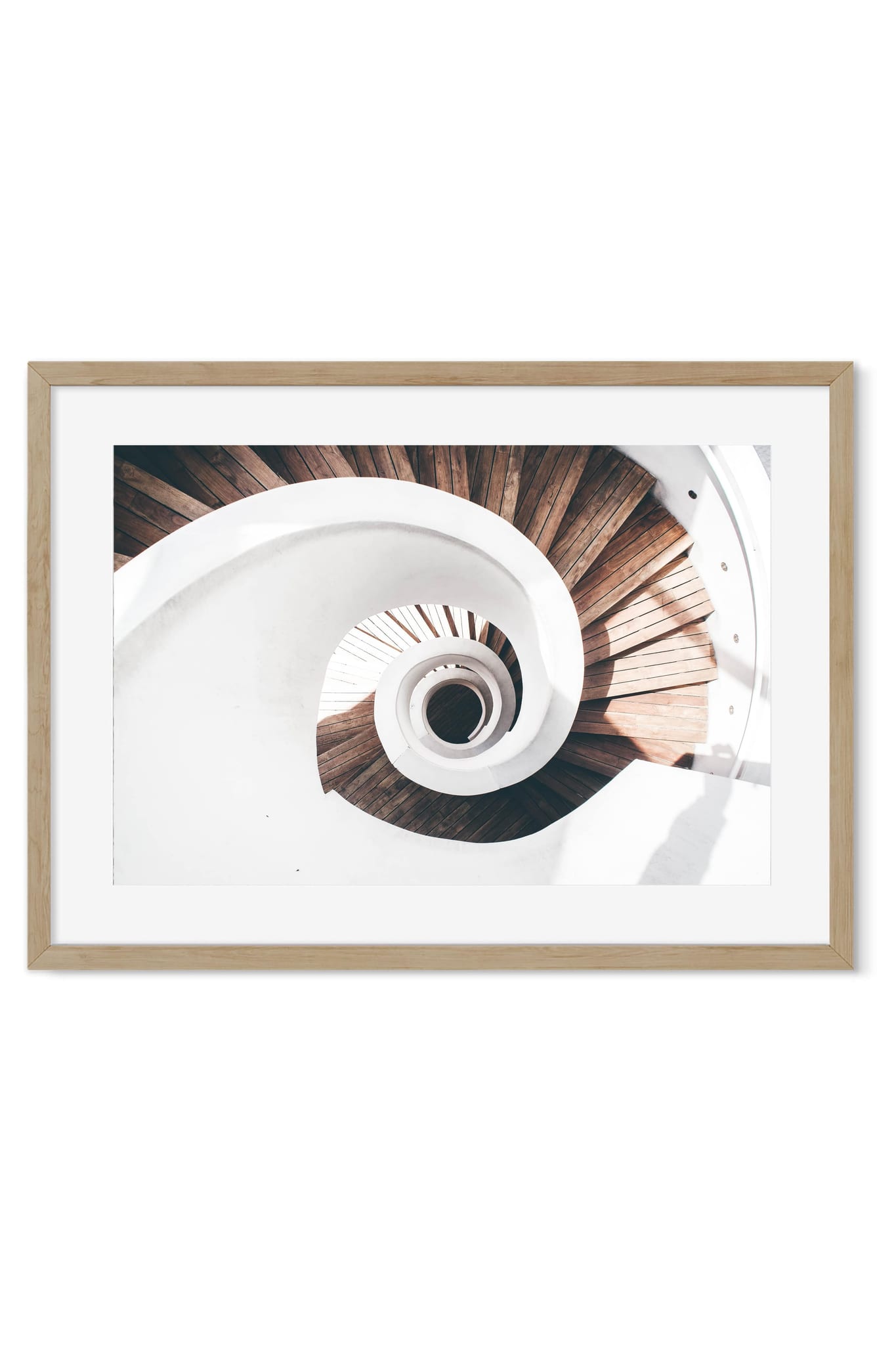 Bird's-eye view down a white spiral staircase with wooden steps