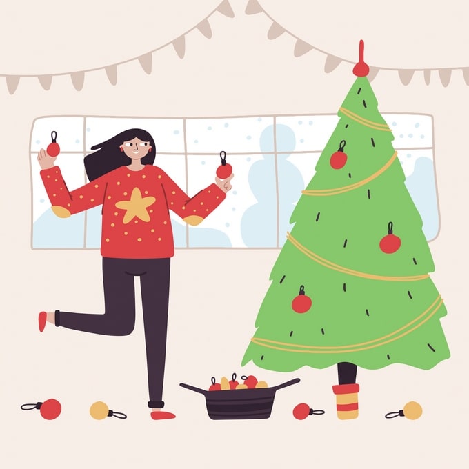Woman in a red star-print sweater hanging ornaments on a Christmas tree beside a snowy window