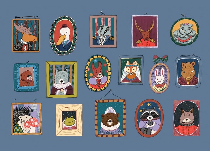 Fifteen framed portraits of forest animals including a moose, fox, owl and bear hung gallery-style