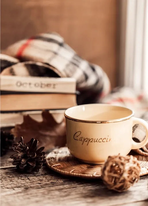 Cozy autumn photo postcard featuring a cappuccino, books, an October detail and a knitted blanket