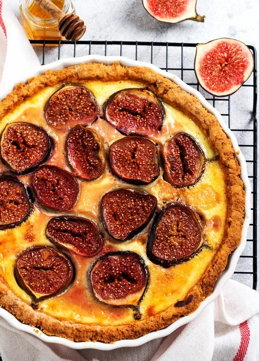 Autumn food postcard featuring a rustic golden fig tart topped with fresh sliced figs