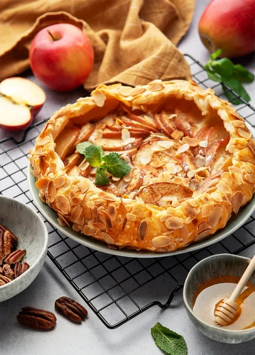 Autumn food postcard featuring a rustic golden apple galette with almond flakes