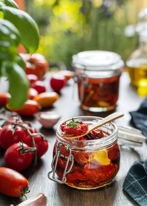 Harvest food postcard featuring sun-dried tomatoes preserved in glass jars with garlic and herbs