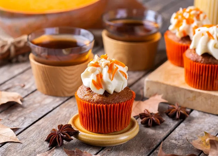 Autumn food postcard featuring spiced cupcakes with creamy frosting, orange zest and star anise
