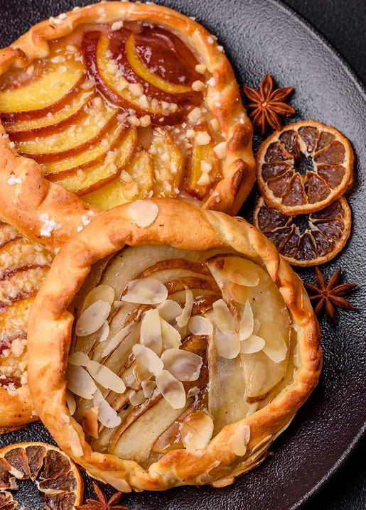 Autumn food postcard featuring rustic apple and pear tarts with almonds and star anise