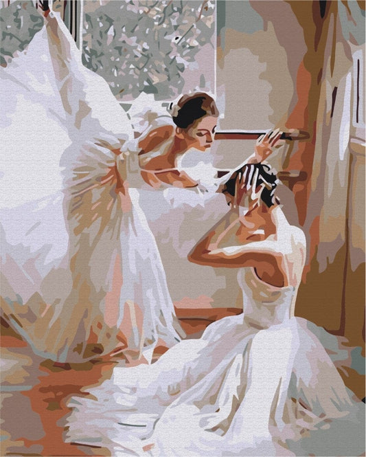 Two ballerinas backstage in white tutus, one stretching at the ballet barre