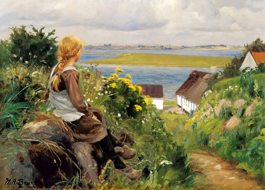 Girl with a blonde braid sits among yellow wildflowers on a hill above a broad Danish fjord.