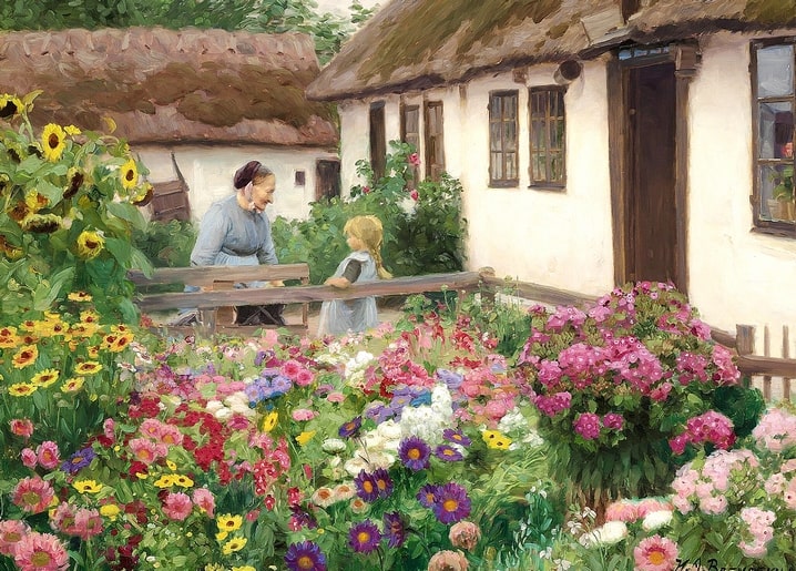 Frau spricht mit einem Mädchen über den Zaun in einem blühenden Bauerngarten