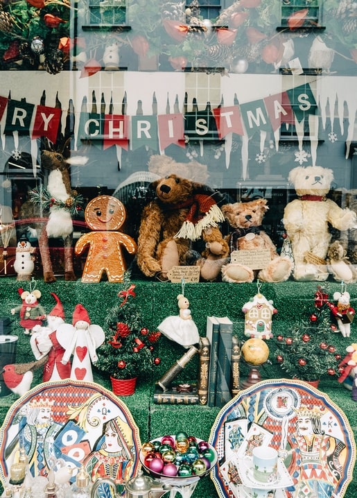 Christmas shop window with teddy bears, gingerbread man and painted plates