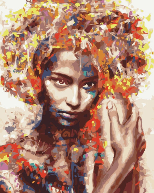 Woman's face beneath hair made of colorful confetti-like abstract fragments