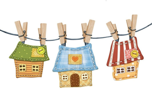 Three patchwork cottages with colorful roofs hanging from a clothesline with wooden clothespins