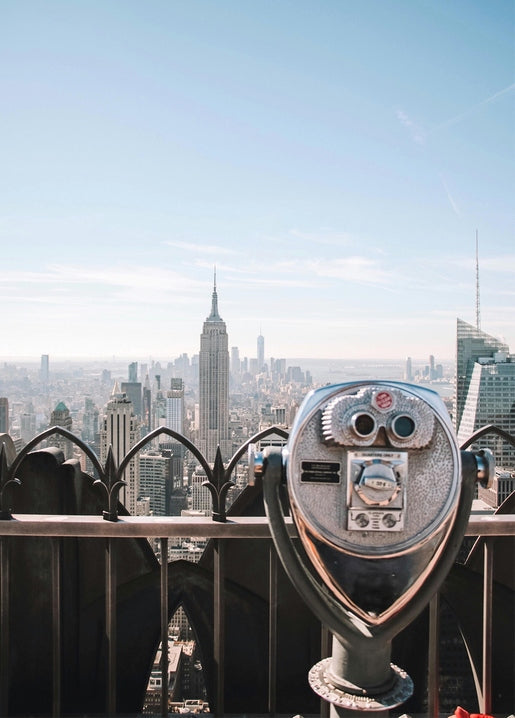 Coin-operated rooftop viewfinder overlooking the Empire State Building and Manhattan skyline