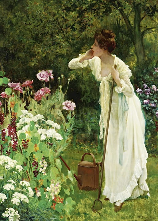 Woman in a white dress leaning on a garden fork beside a watering can, admiring a flowering border