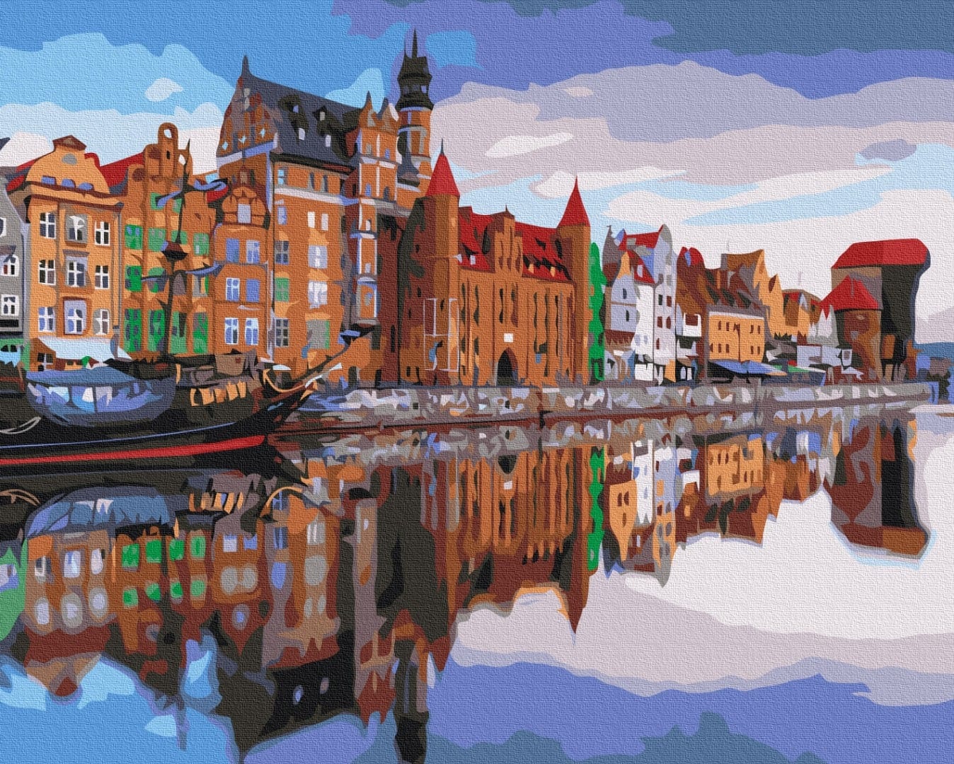 Colorful Gdańsk waterfront houses and a tall ship reflected in calm water
