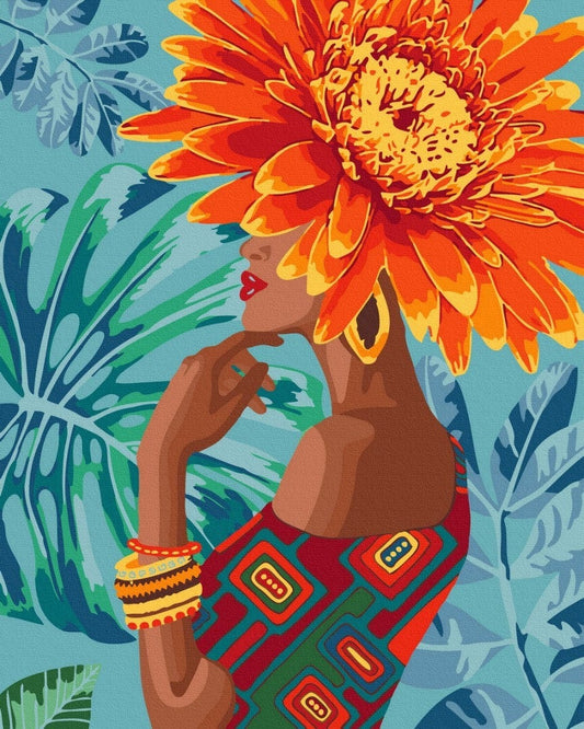Woman in profile wearing a giant orange gerbera flower headdress among tropical leaves