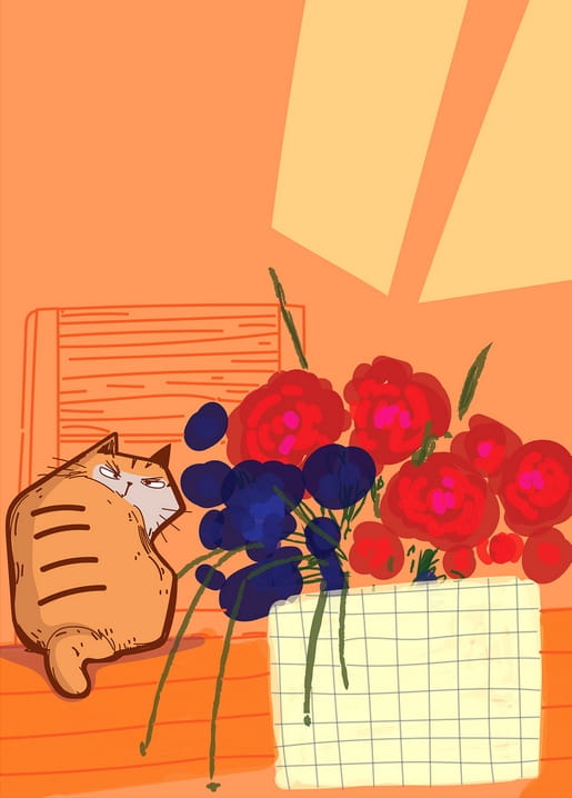 Schmollende rote Katze liegt neben einem Strauß aus roten und dunkelblauen Blüten auf orangefarbenem Tisch