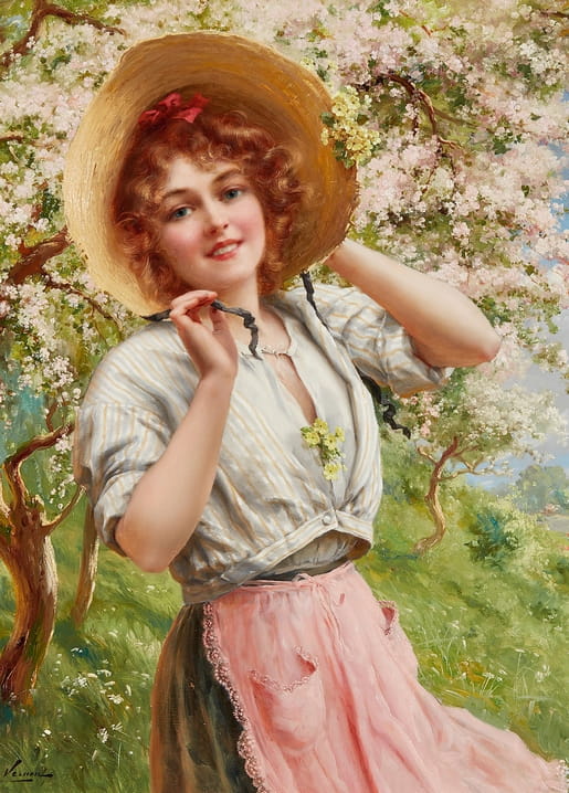 Curly-haired girl in a wide straw hat tying its ribbons beneath a tree in pink and white blossom.