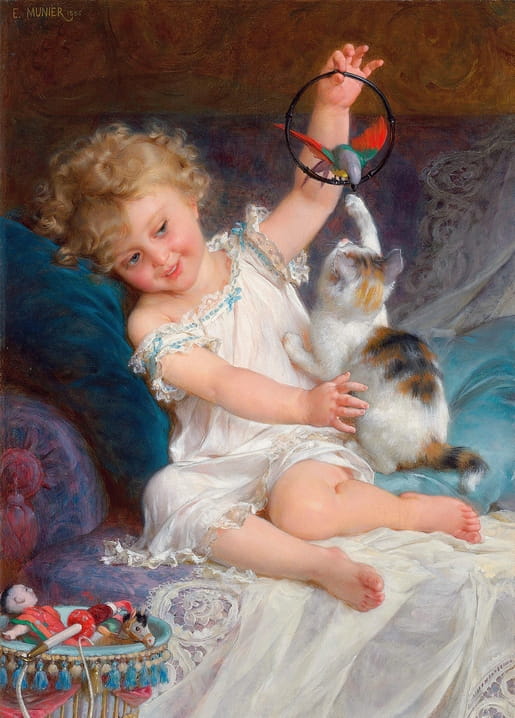 Curly-haired girl on a couch teasing a calico kitten with a toy bird on a hoop