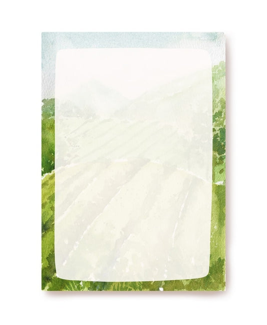 Watercolor letter paper bordered with green hills, furrowed fields, and misty mountains