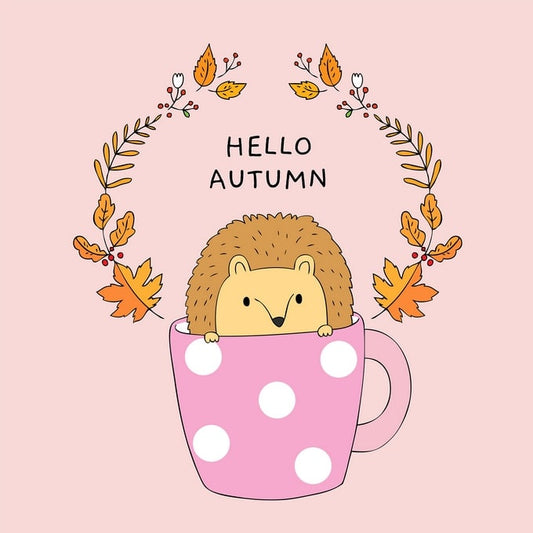 Illustrated postcard of a hedgehog peeking out of a polka-dot mug with an autumn leaf wreath