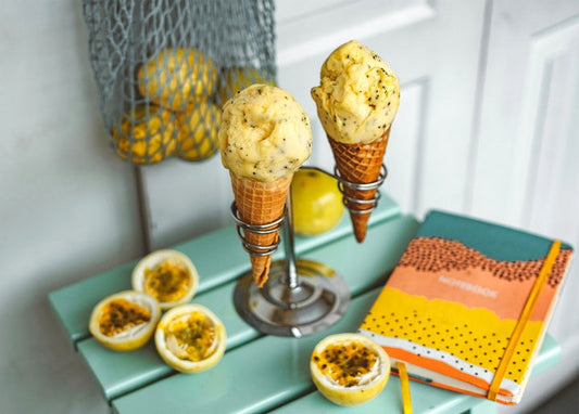 Two ice cream cones with passion fruit halves and a net of lemons
