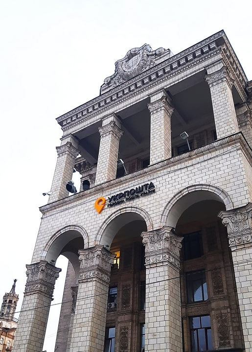 Colonnaded facade of Kyiv's Central Post Office with the orange Ukrposhta logo