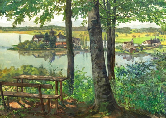 Wooden bench by a lake overlooking Kloster Seeon village and church tower