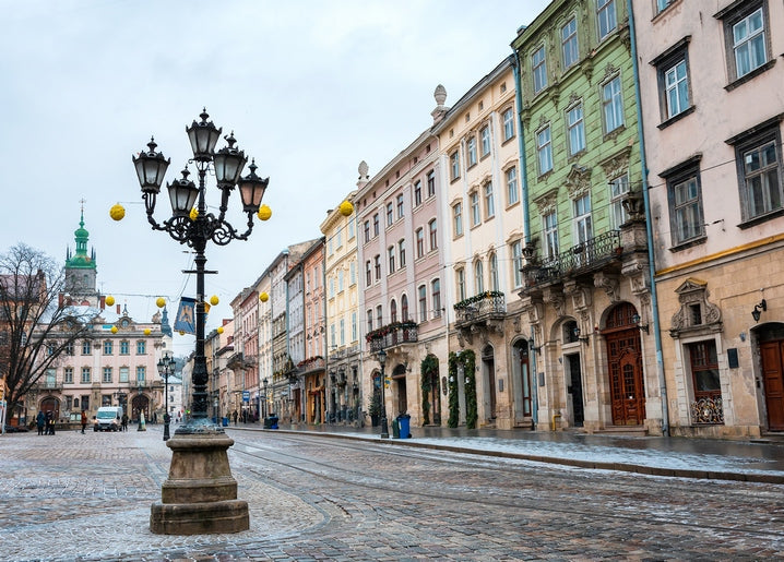 Ornate wrought-iron lamppost on Lviv's cobblestone Market Square