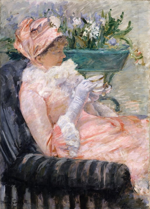 A woman in a pink bonnet sips tea beside a vase of spring flowers — Mary Cassatt's The Cup of Tea.