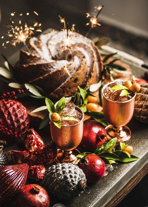 Sparkler-lit bundt cake with copper mule cocktails and pomegranates for New Year's Eve