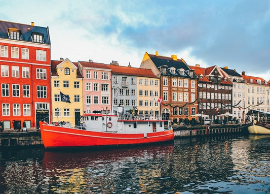 Colorful townhouses and a red boat along the Nyhavn canal in Copenhagen