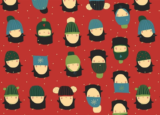 Red pattern of penguins wearing colorful knit hats and scarves in falling snow